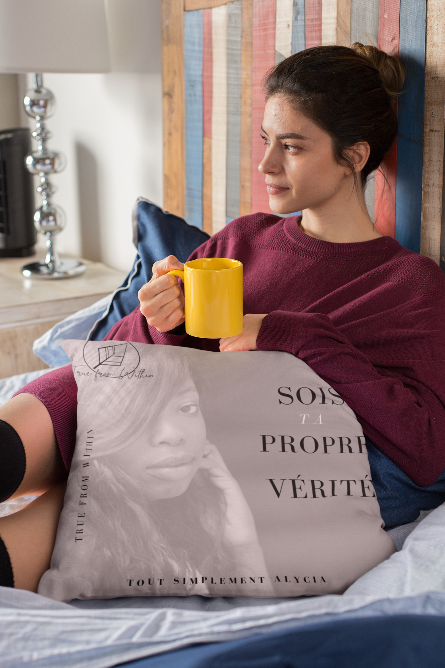pillow-mockup-of-a-woman-sitting-cozily-on-her-bed-drinking-tea-23572